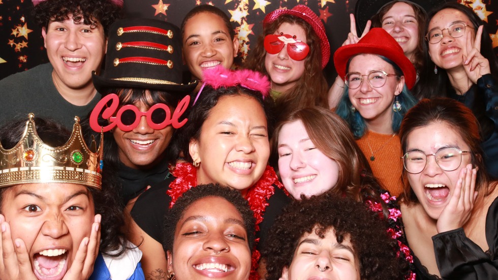 Students wearing a variety of comic hats and glasses.